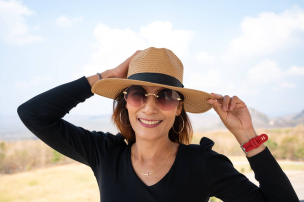 Asian woman with sunglasses on tower, Lampang province. - Foto, Imagen