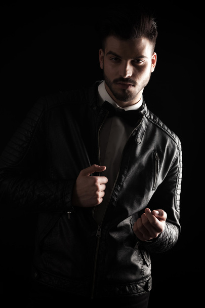 young business man pulling his leather jacket  - 写真・画像
