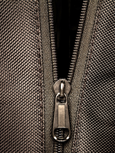 Sepia tone Metal zipper on black synthetic fabric - Photo, Image