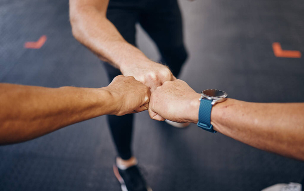 Group fist bump, hands and gym for motivation with personal trainer for health, wellness or training with smartwatch. Team, workout or exercise for fitness goal, muscle development or body healthcare. - Foto, Bild
