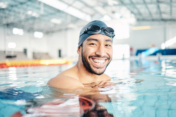 Portrait, man and relax in swimming pool with cap in sports wellness, training or exercise for body healthcare. Workout, fitness and swimmer athlete with happy face, smile or water competition goals. - Foto, imagen