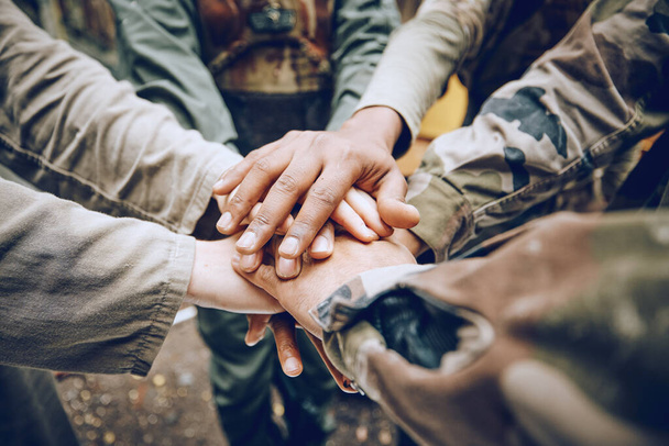 Military, team work or hands in a huddle for a mission, strategy or motivation on a paintball battlefield. Goals, collaboration or army people with support in a partnership or group of ready soldiers. - Photo, Image