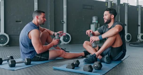 Fitness friends, gym and men drinking water for exercise, workout and training together. Happy people talking about health and wellness goals, achievement and sports performance or diet on ground. - Filmati, video