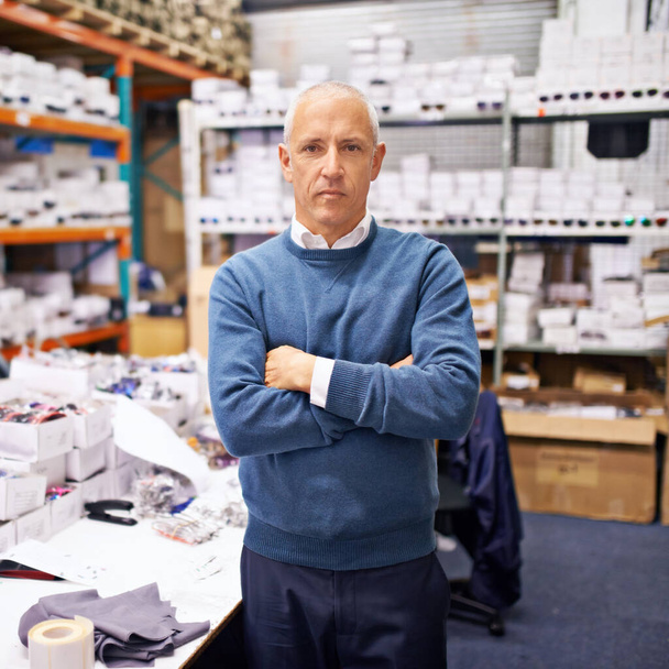 Serious about the companys success. a mature man working inside a printing and distribution factory - Photo, Image