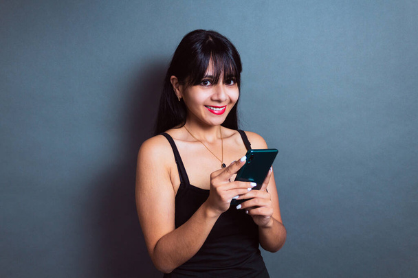 happy hispanic student using cell phone. young business woman chatting - Foto, Imagen
