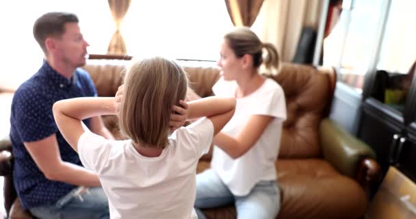 Girl daughter upset closes ears parents quarrel. Sad little girl upset by psychological problems - Séquence, vidéo