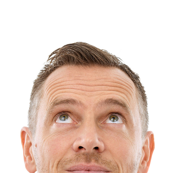Man face, looking up and mockup space for thinking, advertising or promotion isolated on a white background. Person with copyspace idea for logo, brand or barber sale with eyes and studio headshot. - Foto, immagini