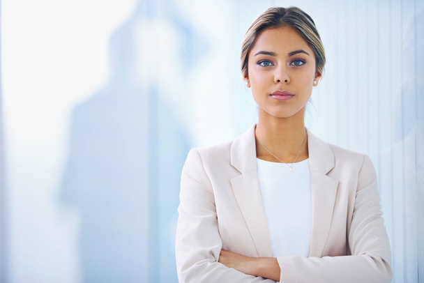 Brimming with confidence. Portrait of an attractive young businesswoman standing in an office - Foto, immagini