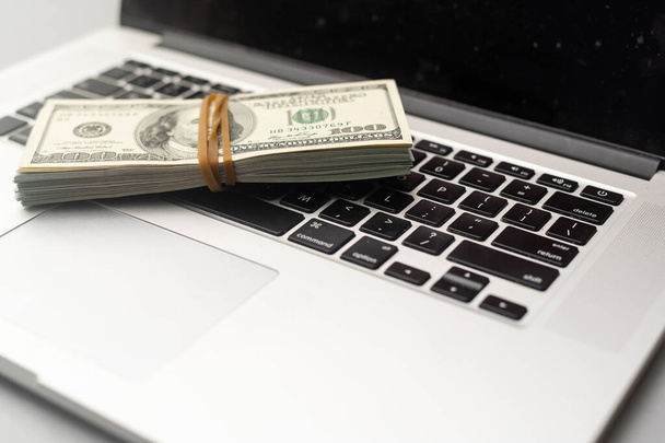 Visualize financial success with money on a laptop keyboard. Perfect for businesses, financial advisors, and those driven to succeed. High quality photo - 写真・画像
