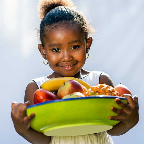 süßes afroamerikanisches Mädchen mit Obstschale. - Foto, Bild