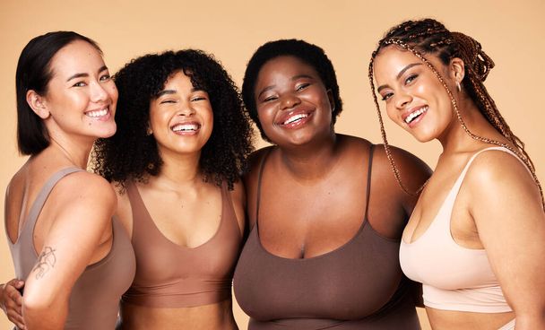 Friends, diversity and beauty of women in underwear in studio isolated on a brown background. Portrait, lingerie and self love of body positive happy girls with makeup, cosmetics and healthy skincare. - Fotó, kép
