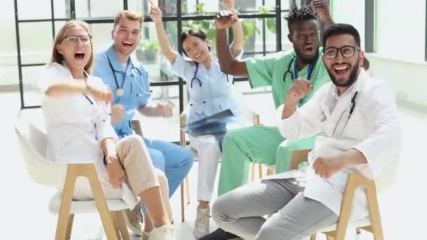 Group of doctors celebrating victory in a hospital - Felvétel, videó