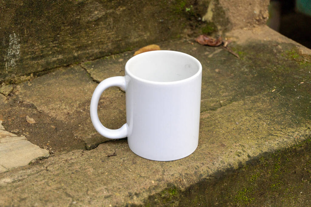 A peaceful scene with a white mug on stone stairs, perfect for a morning coffee break - Foto, Bild