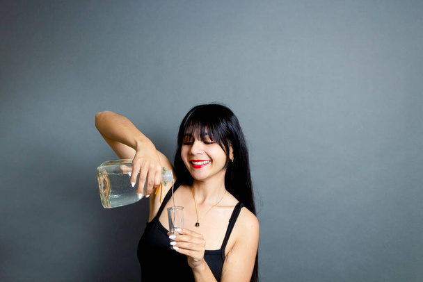 happy woman serving shot of silver tequila - Φωτογραφία, εικόνα