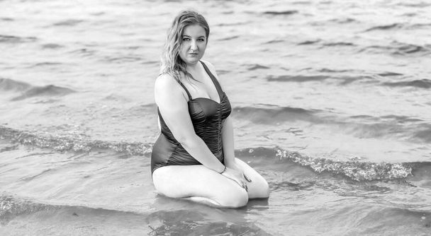 Plus size woman in water in swimsuit. Chubby nice lady, body positive concept, different women sizes - Photo, Image