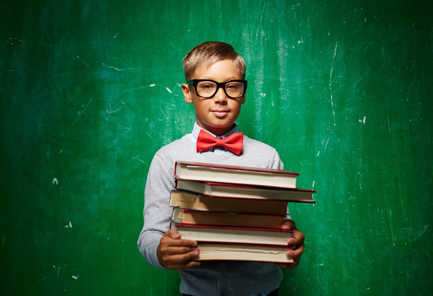 Pupil  in eyeglasses  with books - 写真・画像