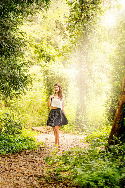 Portrait of beautiful young woman in a forest - Photo, Image
