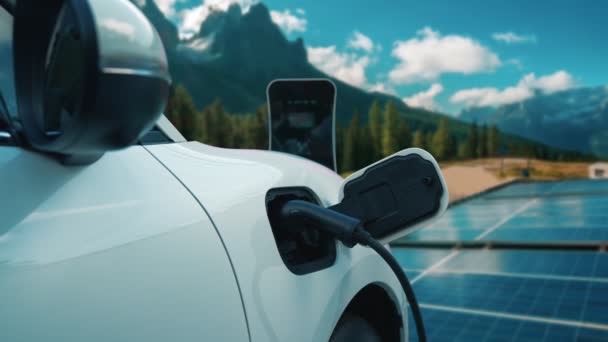 Концепция прогрессивного будущего возобновляемых и чистых энергетических технологий с помощью зарядных станций подзарядки EV аккумуляторов автомобилей на солнечных батареях для экологически чистой устойчивой энергетической системы. - Кадры, видео