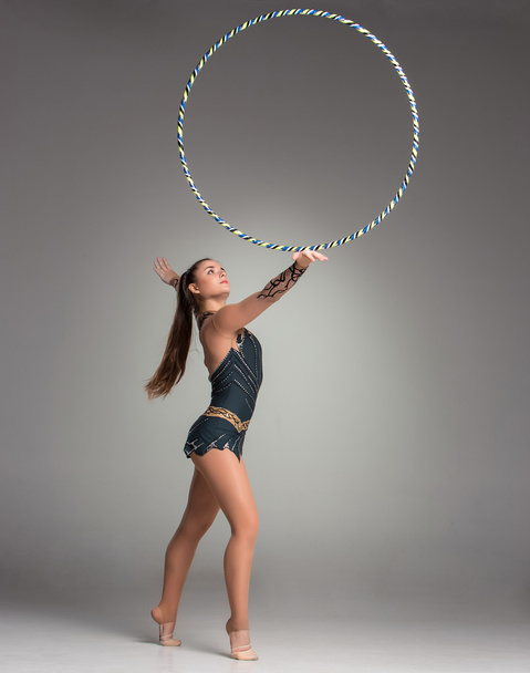 teenager doing gymnastics exercises with gymnastic hoop - Fotoğraf, Görsel