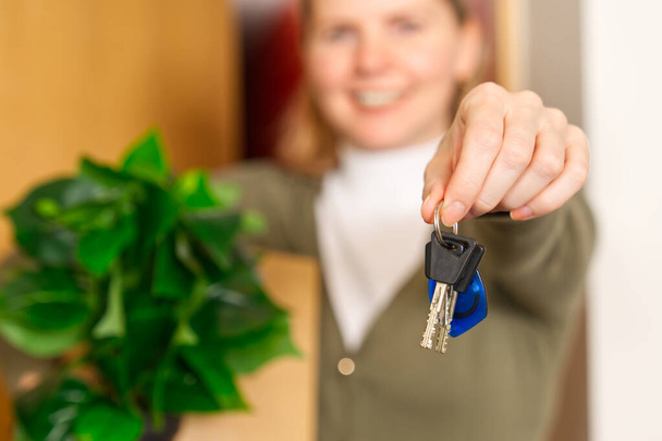 Starting new life. Overjoyed woman hold keys from new apartment or home. new life starts now. Excited woman proud of becoming homeowner first time. loan, mortgage concept - Fotografie, Obrázek