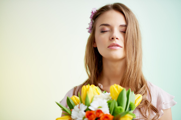 Woman with fresh flowers - Фото, изображение