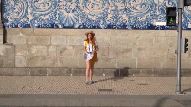 Young tourist woman with map walking in an old Porto town, against azulejo wall. enjoying a vacation in Europe.  - Video