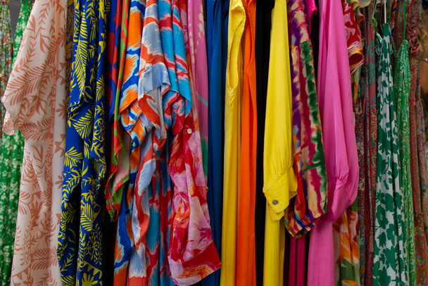 city boutique market shop several women blouses and tops on rack to create colorful fashion background store for women clothing - Foto, Imagen