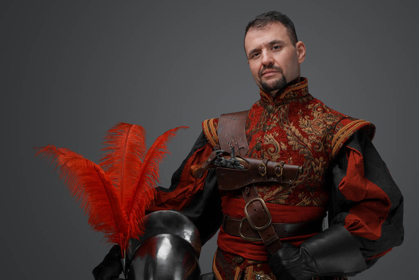 Shot of handsome musketeer man with beard dressed in stylish costume. - Φωτογραφία, εικόνα