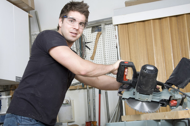 Carpenter at work on job using power tool - Foto, imagen