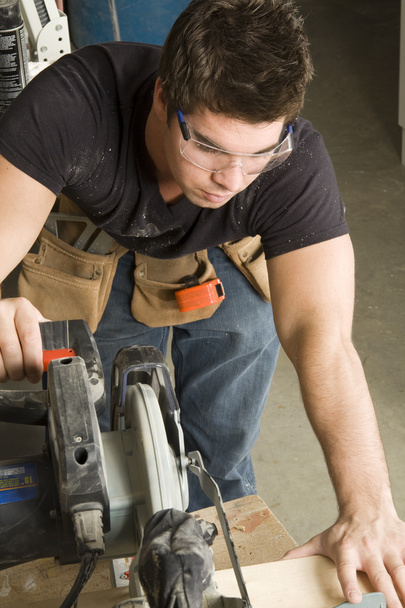 Carpenter at work on job using power tool - Photo, Image