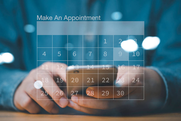 Empresario usando smartphone para reservar plan de agenda de negocios en el calendario de pantalla virtual, concepto de gestión de proyectos. - Foto, imagen