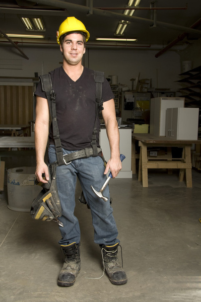 Carpenter at work on job using power tool - Foto, imagen