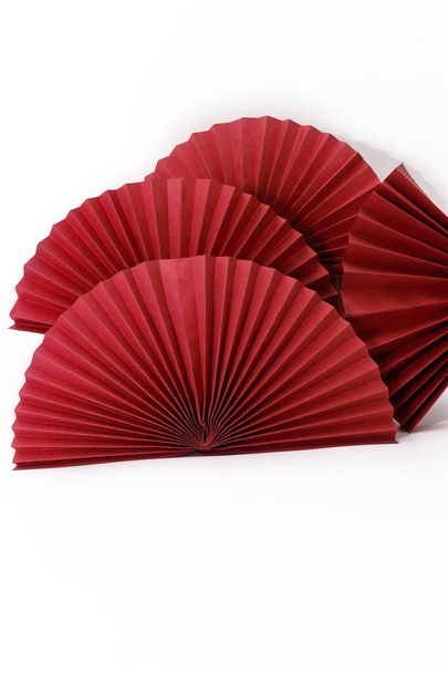 Red circle handmade paper fans on white background. Chinese New Year 2023 background. Copy space - Photo, Image