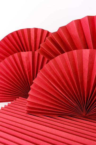Red circle handmade paper fans on white background. Chinese New Year 2023 background. Copy space - Фото, зображення