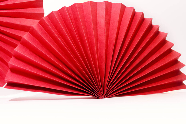 Red circle handmade paper fans on white background. Chinese New Year 2023 background. Copy space - Foto, Imagem