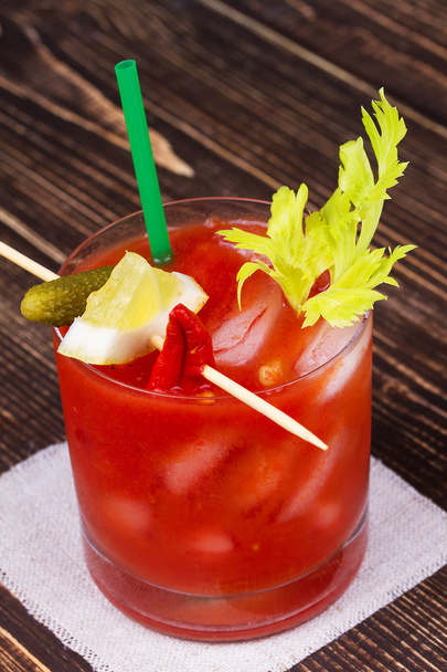 Spice and Salt Bloody Mary Cocktail on wooden background - 写真・画像