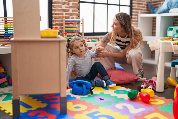 Teacher and toddler playing at kindergarten - Photo, Image