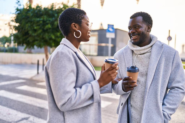 Man and woman couple standing together drinking coffee at street - Photo, Image