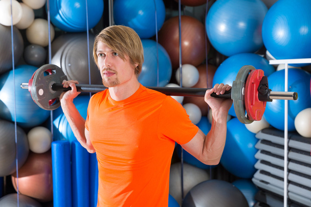 barbell squats blond man at gym exercise - Fotografie, Obrázek
