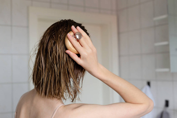 Mulher faz uma auto-massagem na cabeça para o crescimento do cabelo. - Foto, Imagem