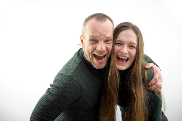 cheerful photo adult man and young girl woman leaning open laugh sincerely look into frame space for text joy luck success mutual understanding friendship real people eyes wide open white background - Valokuva, kuva