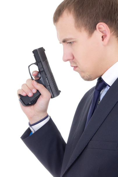 Zobacz Profil poważnego człowieka w garniturze z pistoletu na białym tle o - Zdjęcie, obraz