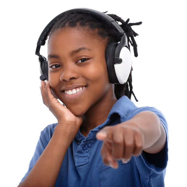 Word. An African-American boy listening to music over his headphones - Photo, Image