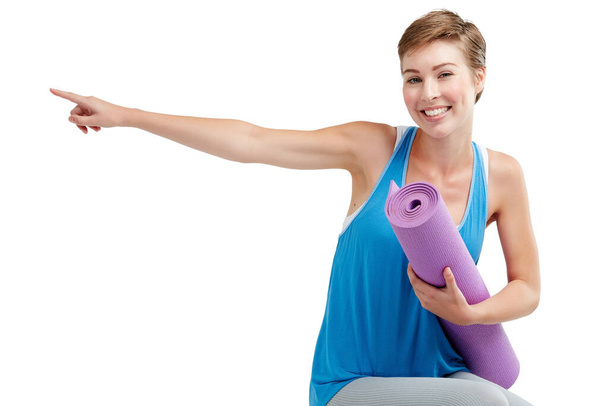 Yoga, pointing and woman isolated on a white background with training gear for product placement on mockup. Happy fitness, exercise or workout person in pilates, sports portrait show space in studio. - Foto, immagini