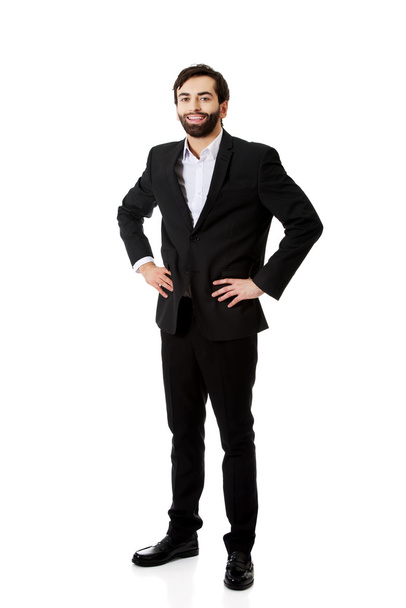 Smiling businessman with hands on hips. - Photo, image