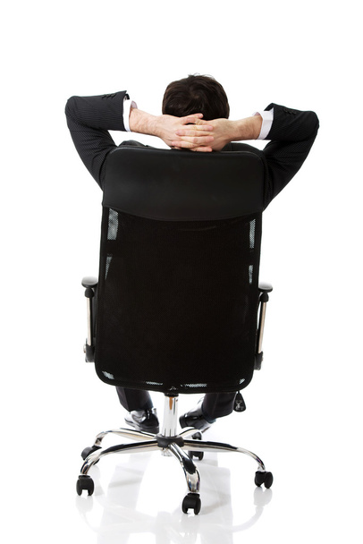 Young businessman sesting on a chair. - 写真・画像