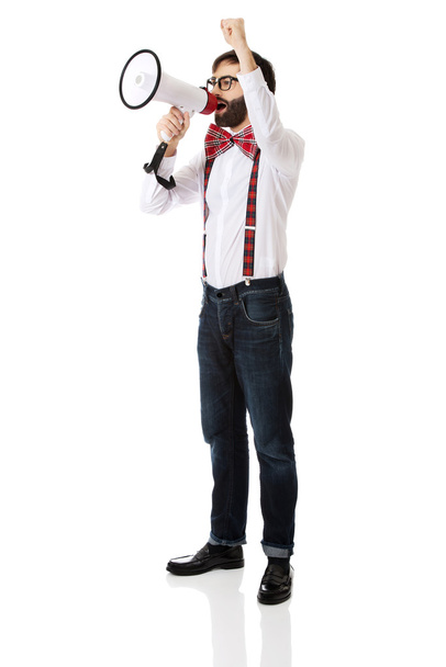 Man wearing suspenders with megaphone. - Foto, afbeelding