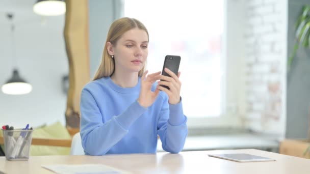 Successful Young Woman Celebrating Win on Smartphone - Záběry, video