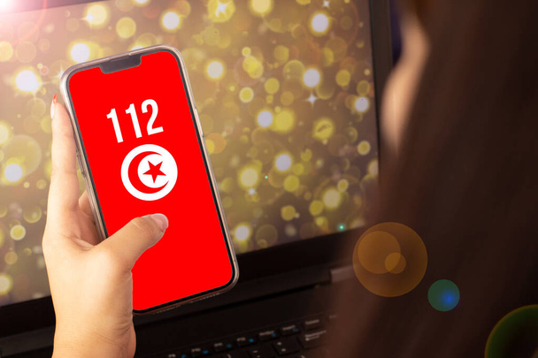 beautiful woman living on the cell phone the flag of turkey with the numbers 112 emergency - Zdjęcie, obraz