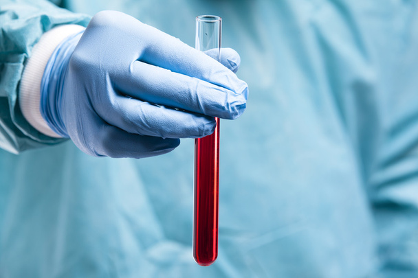 Scientist hand holding a sample of blood - Φωτογραφία, εικόνα